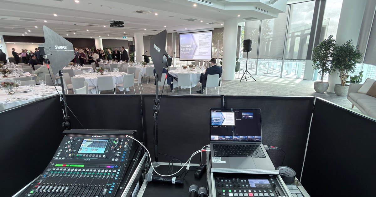 Audio mixing desk, vision switcher and laptop at the back of a corporate lunch