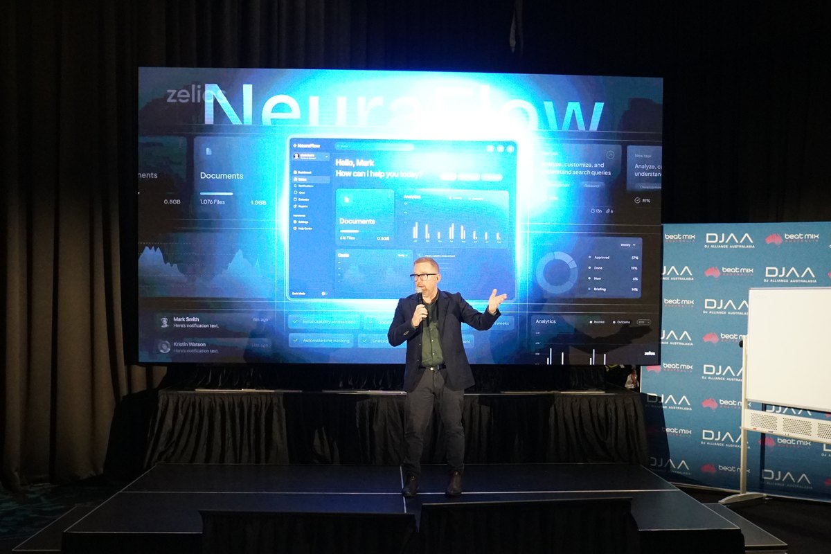 Presenter on stage in front of a large LED wall