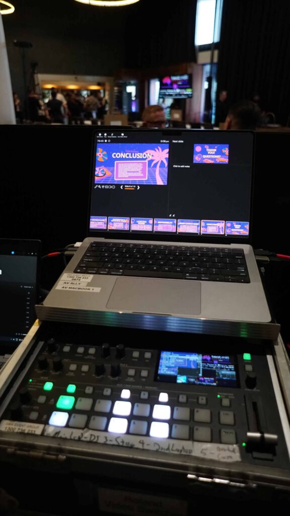 Presentation laptop above a vision switcher at the production desk